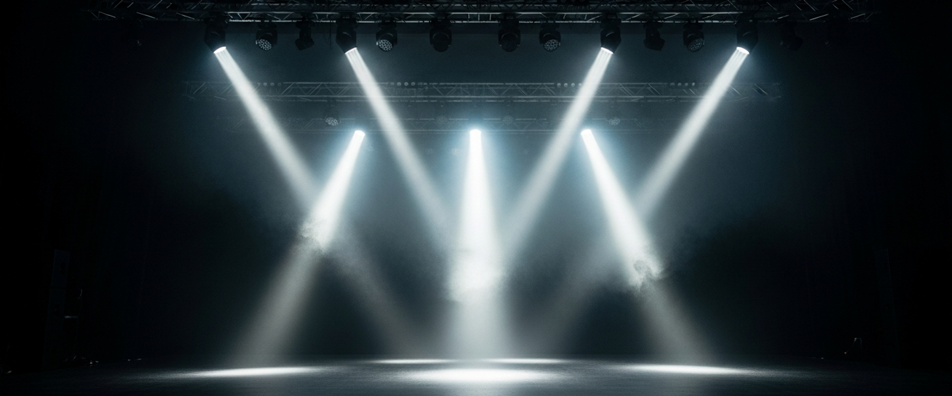 Corporate event stage with dramatic spotlights and atmospheric haze