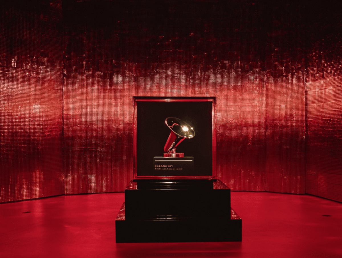 Grammy trophy displayed in red-lit room