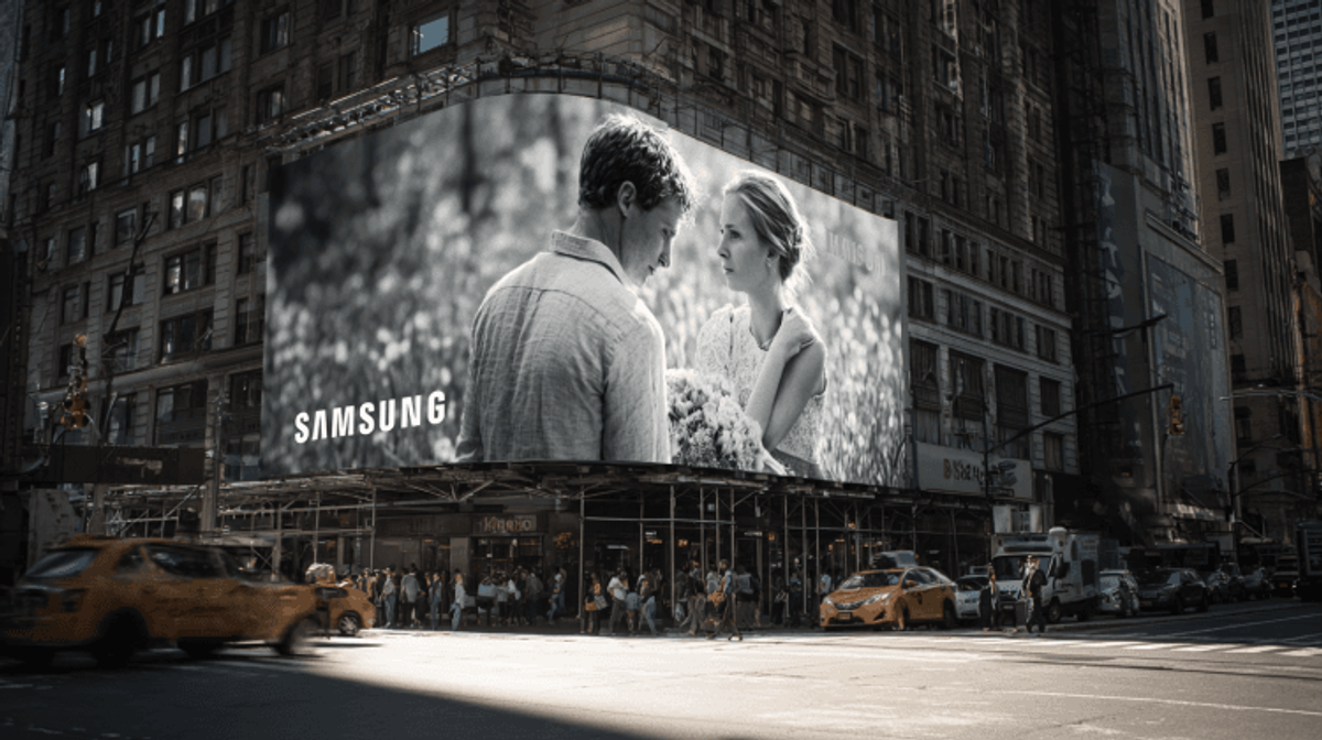 Samsung billboard with couple in busy city intersection.