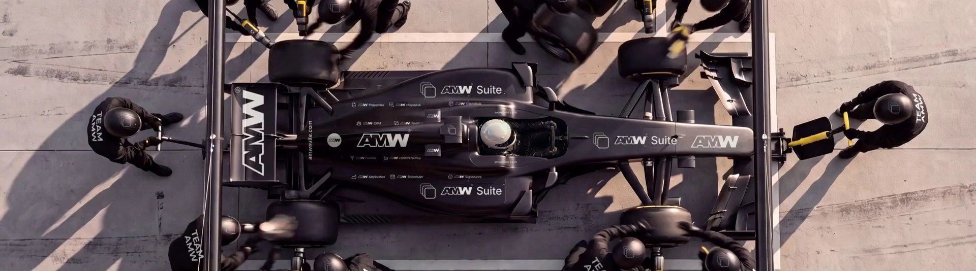 A Team AMW pit stop from above: four new tyres, the all-clear, and the car leaves in a cloud of tyre smoke