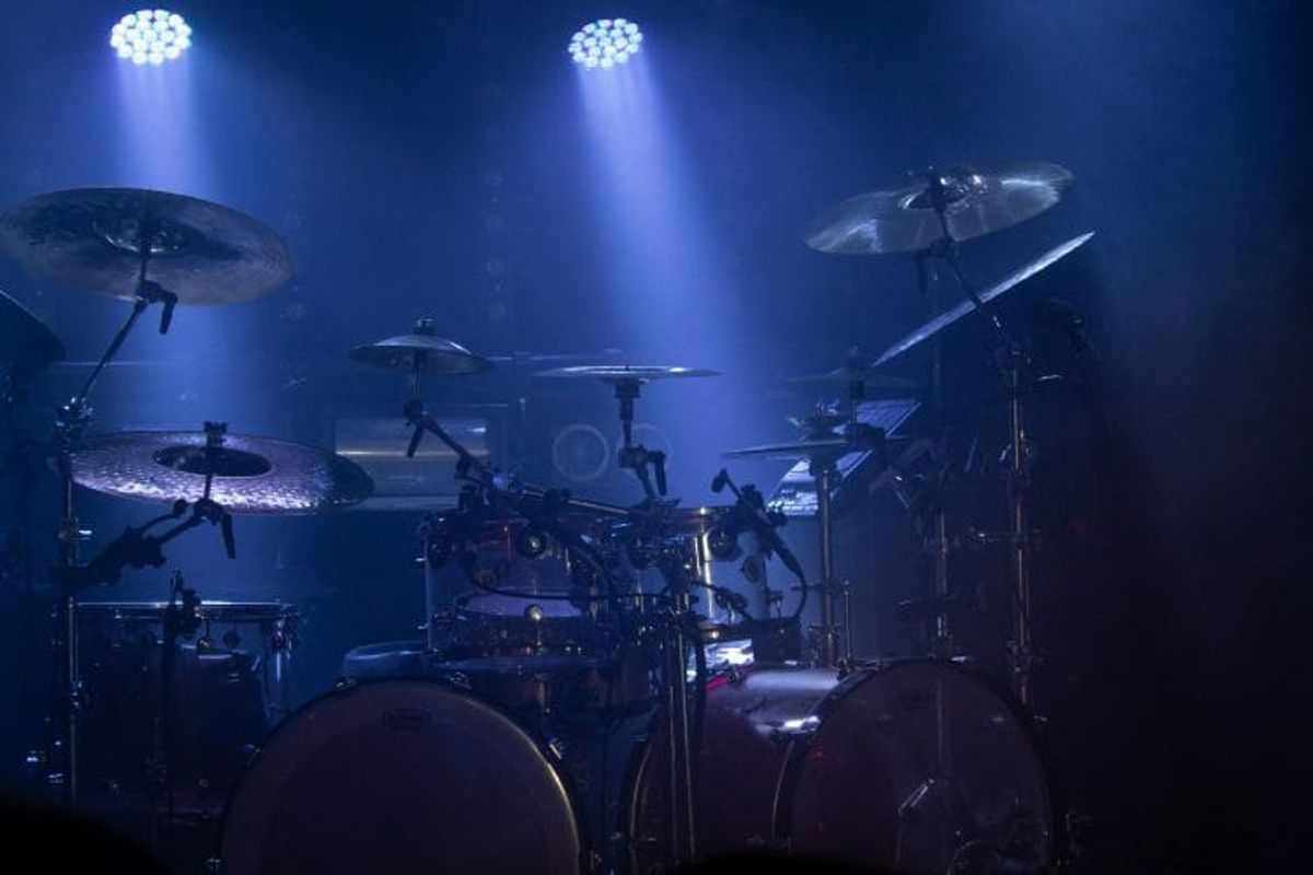Drum kit illuminated by stage lights