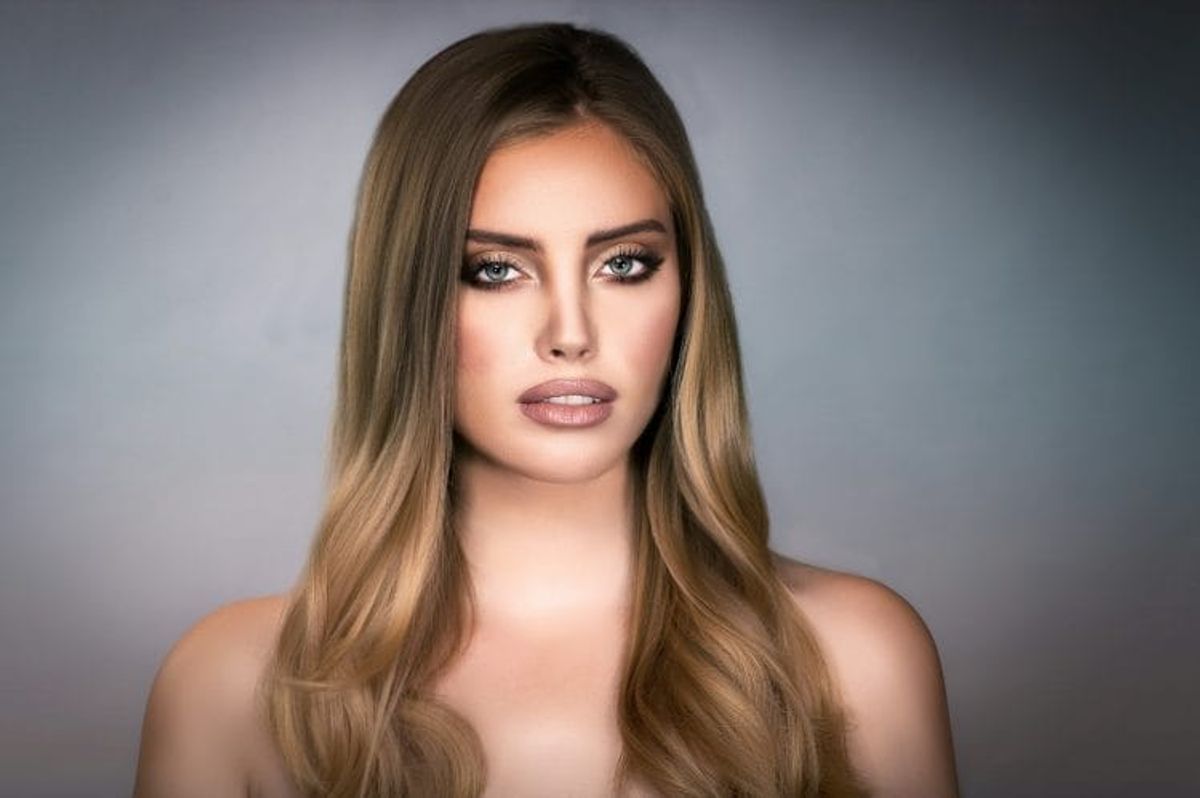 Portrait of woman with long blonde hair.