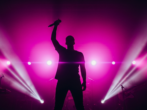 Music promotion services - dramatic stage performance with vivid lighting