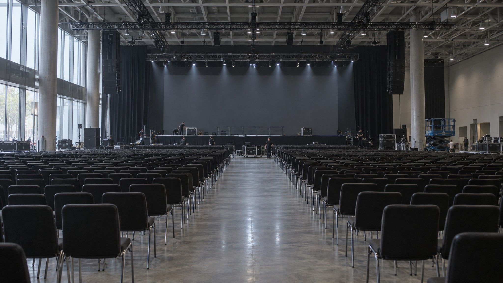 Huge convention hall with a centre aisle between rows of chairs
