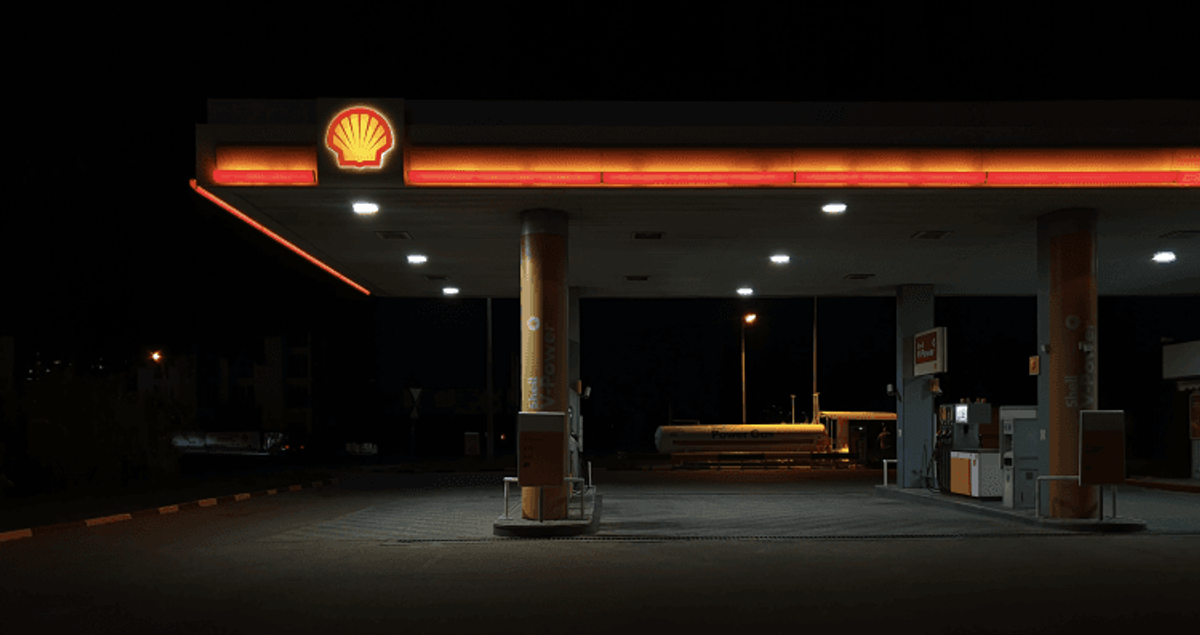 Shell gas station at night, illuminated canopy.