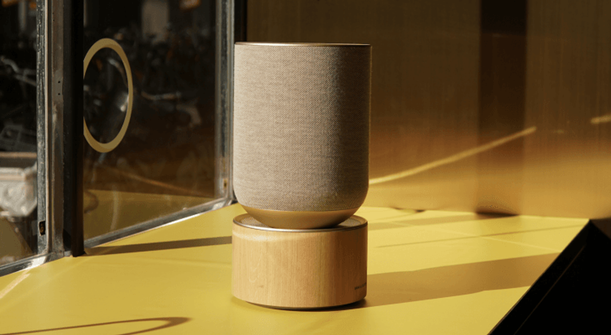 Stylish speaker on a yellow table by window.