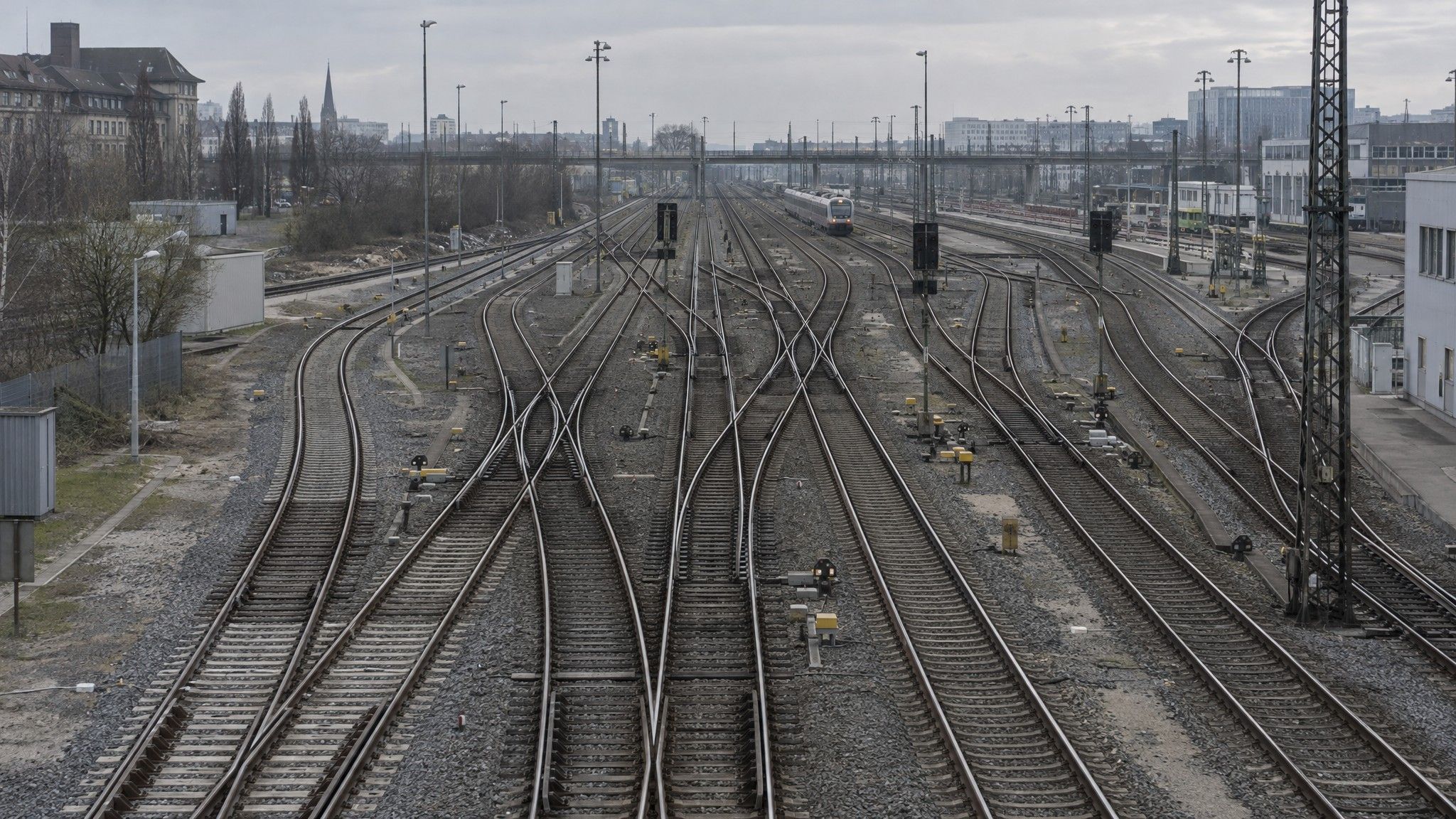 Railway tracks converging and branching seen from a footbridge