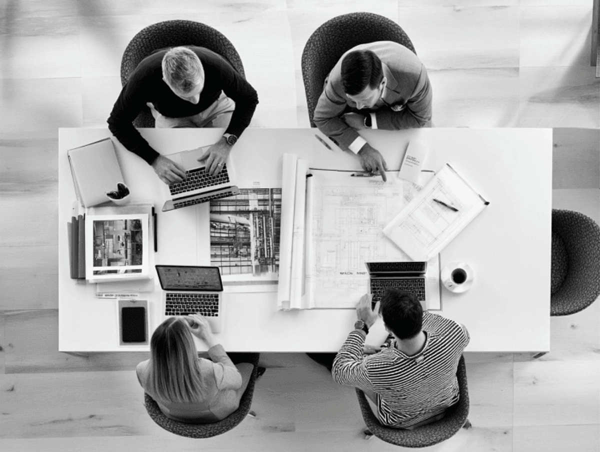 Team collaborating on architectural project in office.