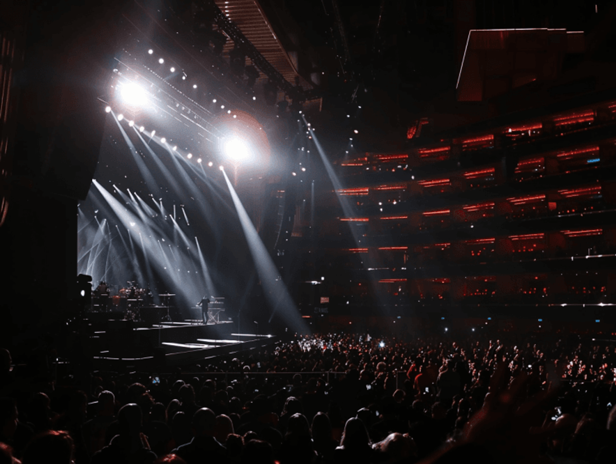 Concert stage with bright lights and audience.