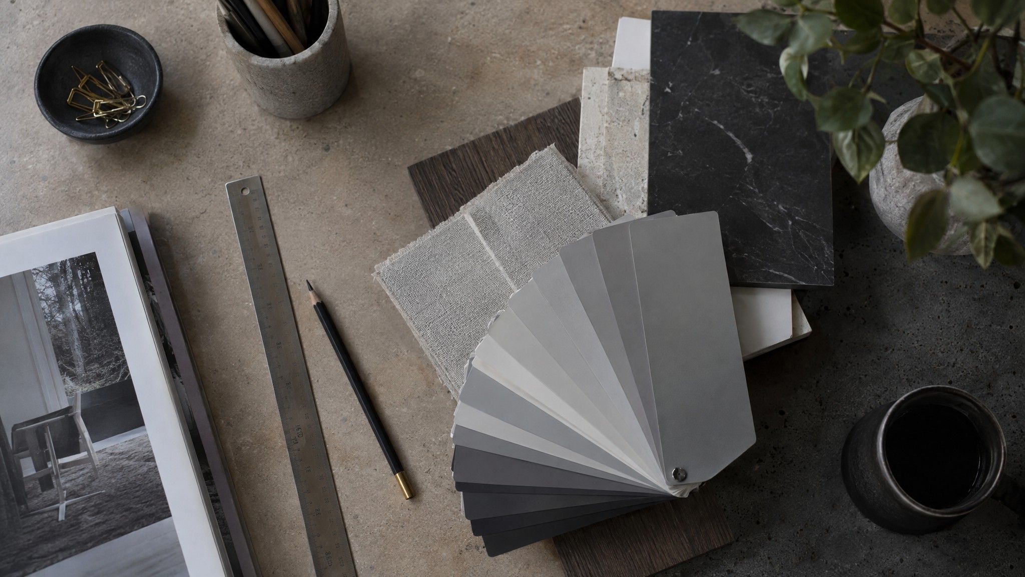 Fan of grey and black paint chips with a ruler and pencil