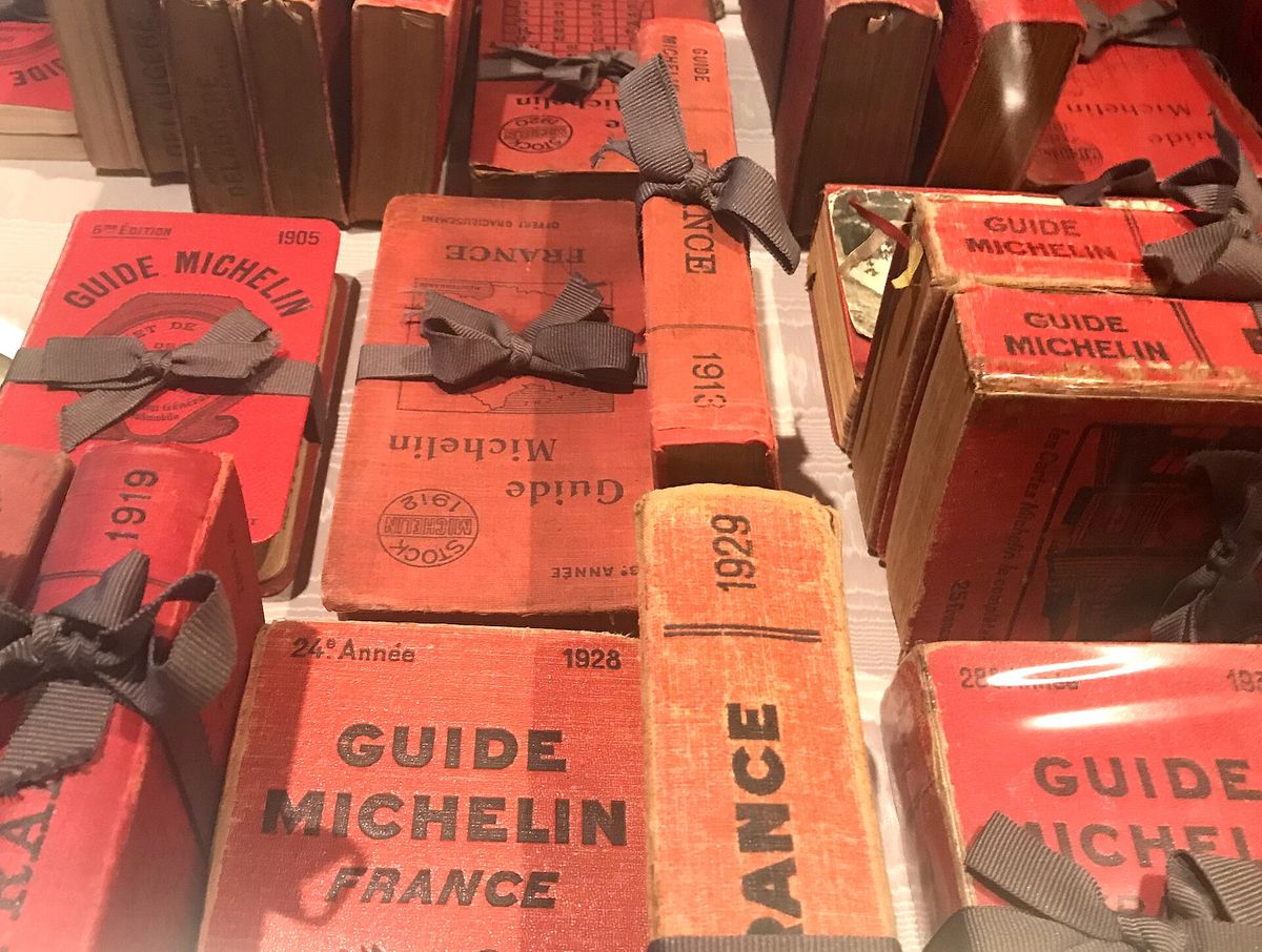 Early red Michelin Guides from 1905 to 1929, tied with grey ribbon, displayed at Maison Pic in Valence