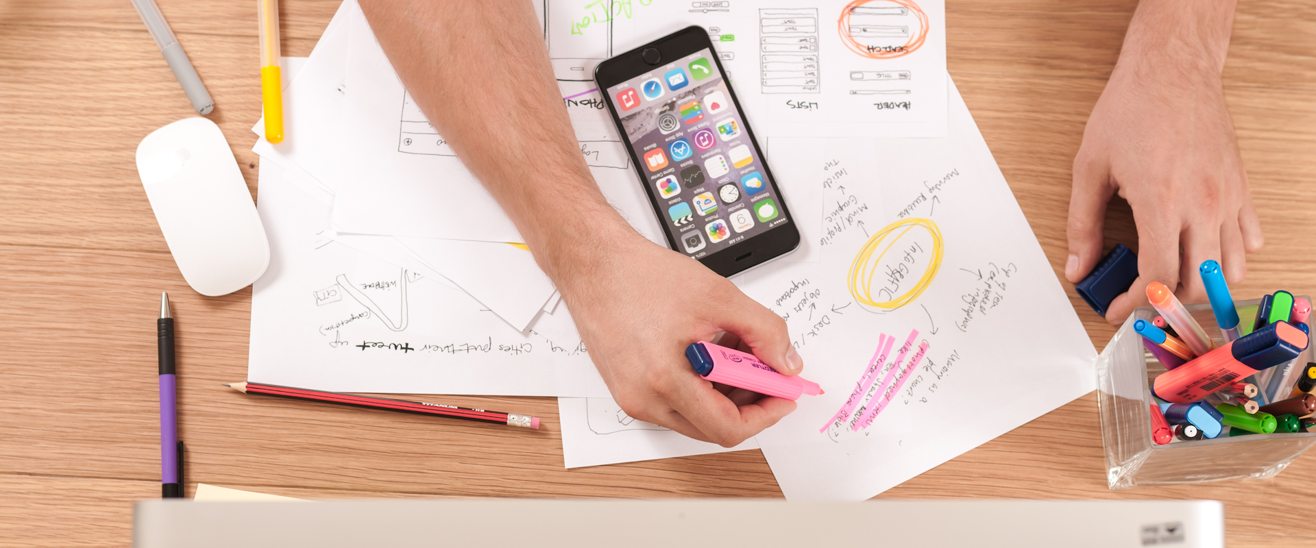 Creative professional working on content strategy with laptop and notebooks on a desk