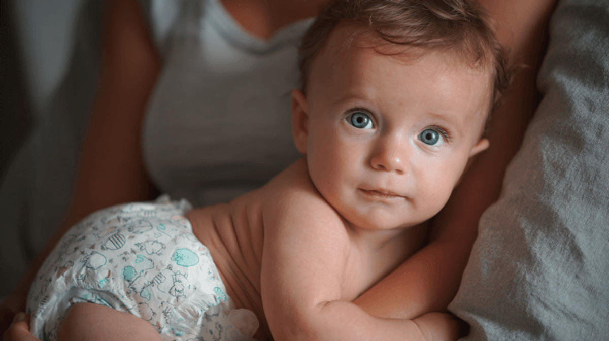 Baby in diaper looking forward