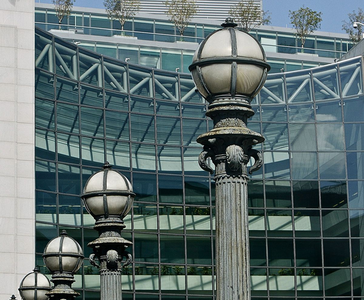 Ornate cast-iron street lamps in front of the curved glass facade of the U.S. Securities and Exchange Commission headquarters in Washington