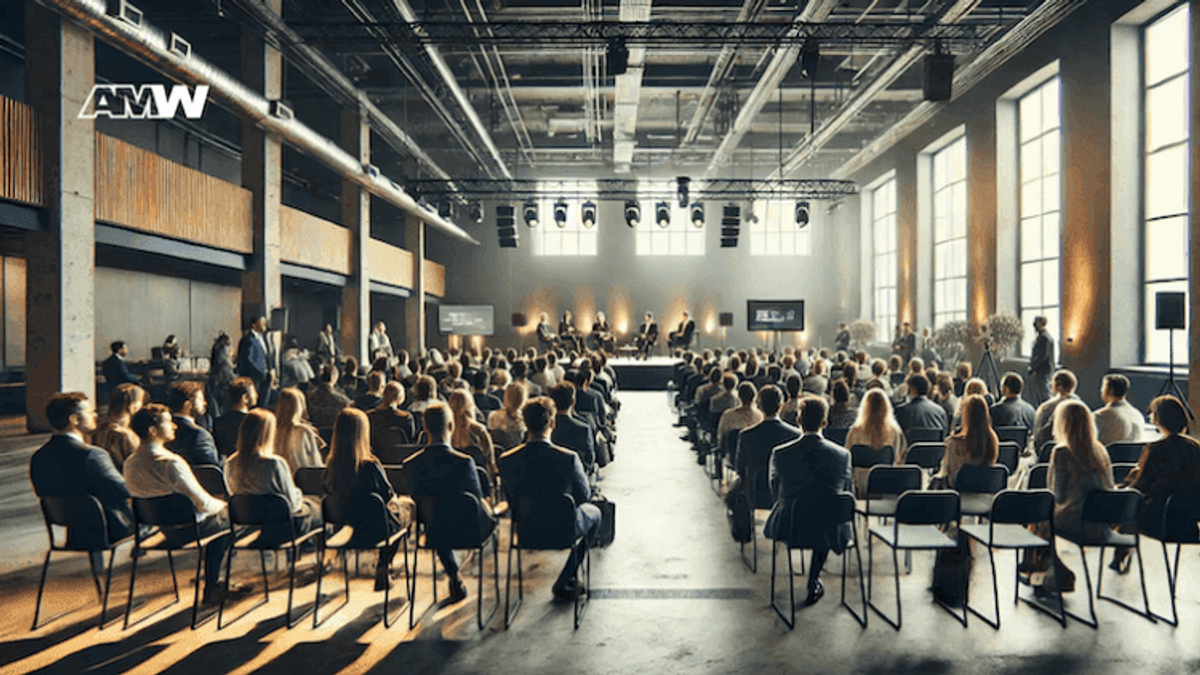 Business conference with audience and panel speakers.