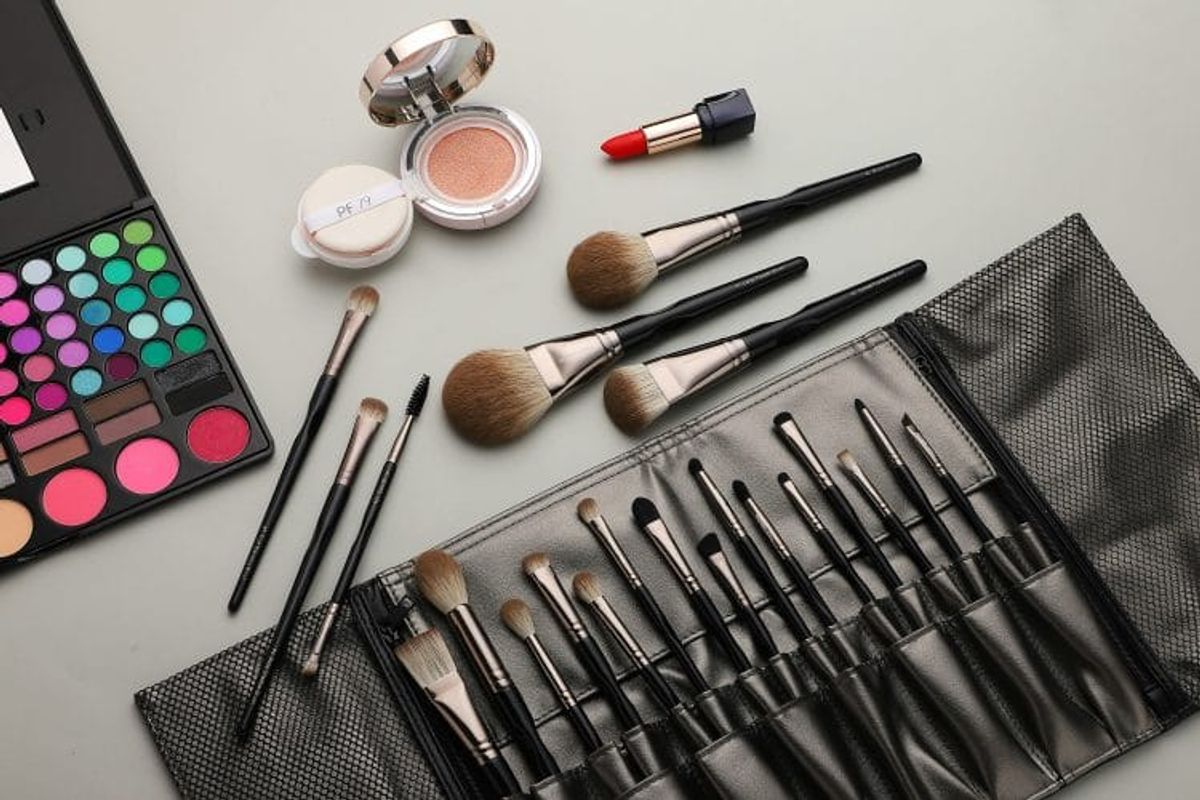 Makeup set with brushes, palette, lipstick.