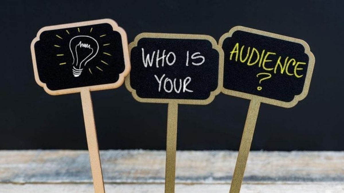 Lightbulb and 'Who is your audience?' signs