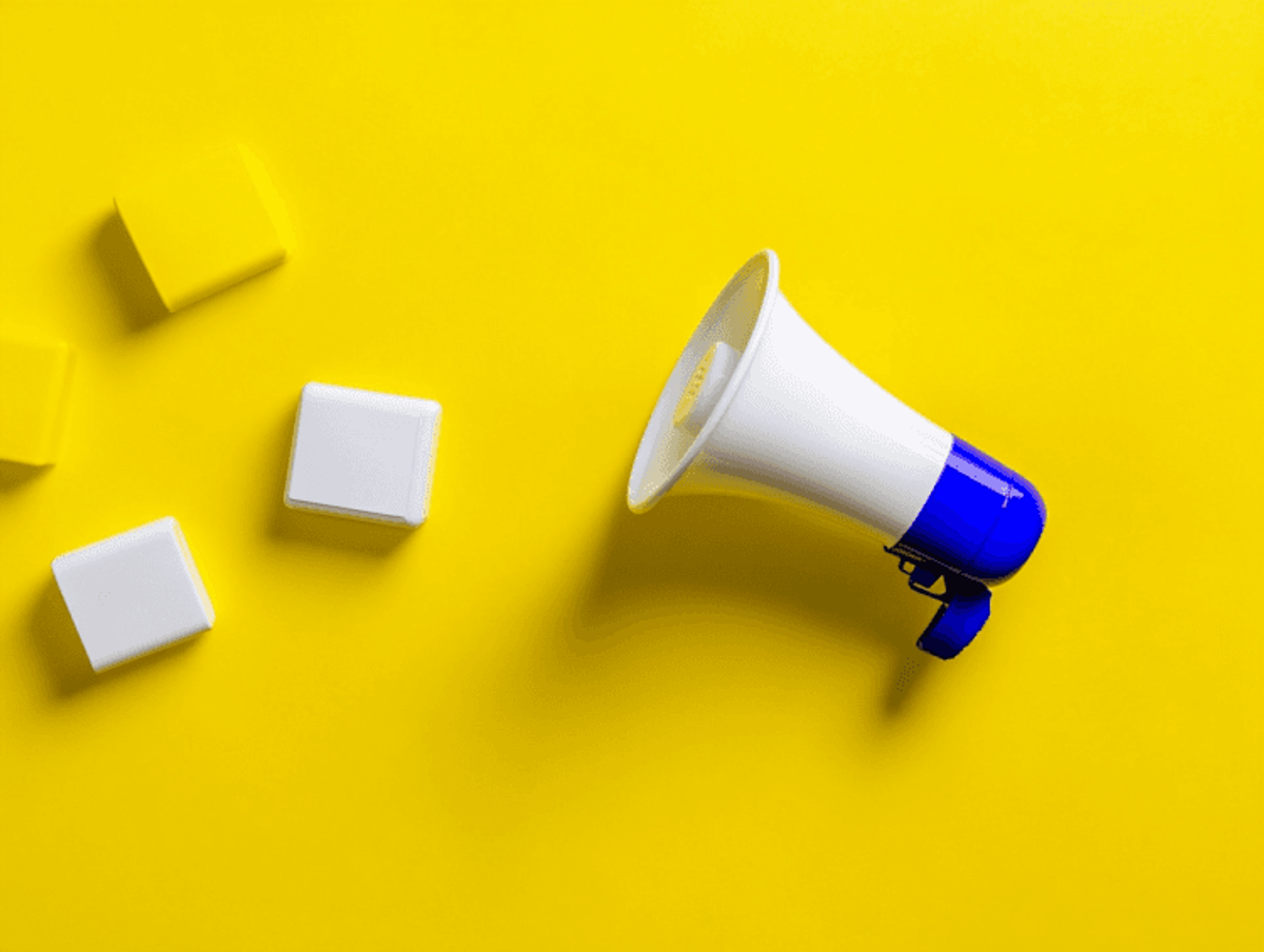 Megaphone on yellow background with white blocks