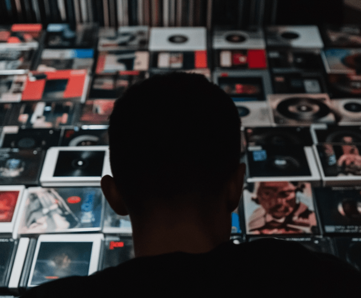 Person viewing a collection of vinyl records
