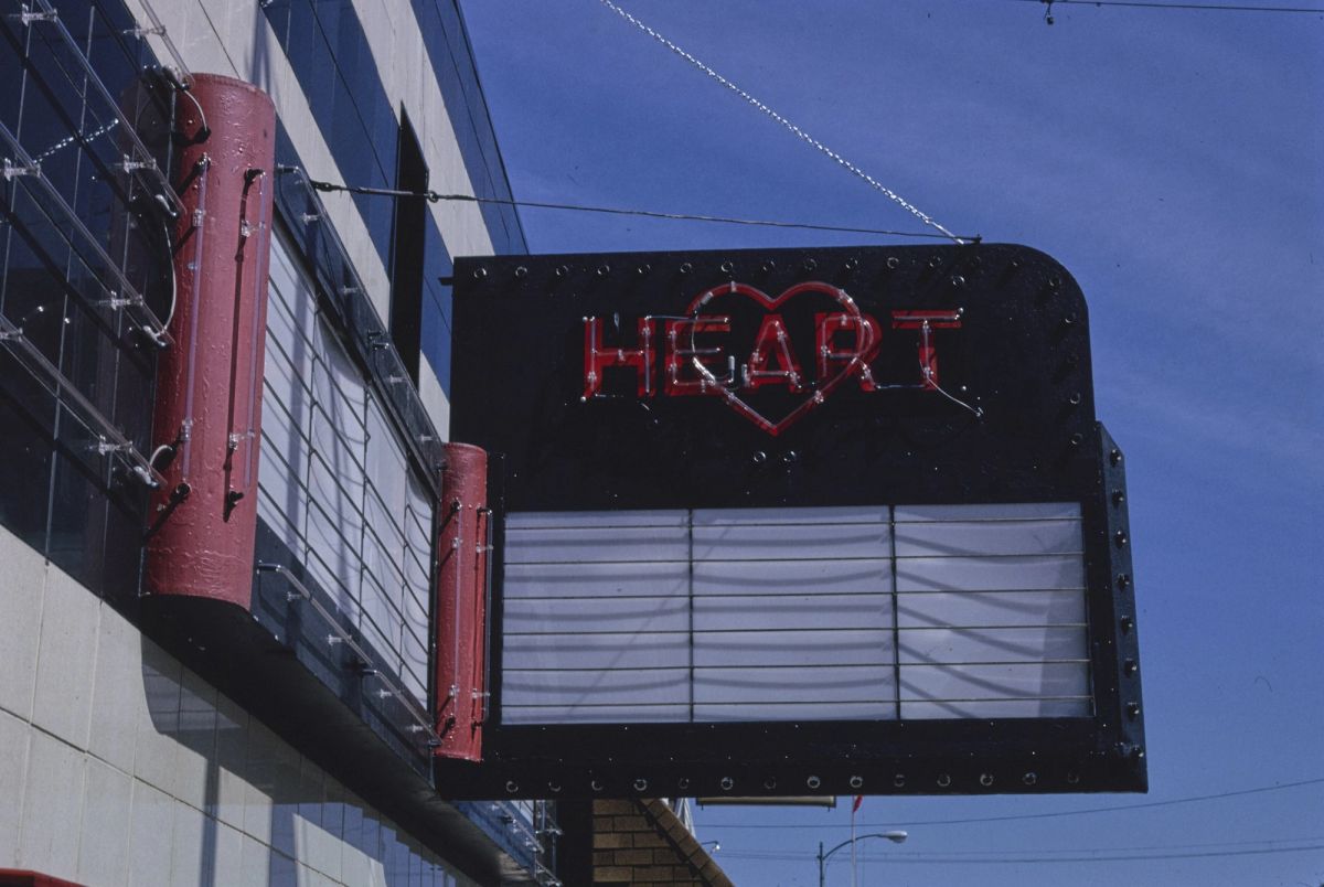 The Heart Theater marquee on Main Street in Hartford, Michigan, with red neon letters and a heart above a blank letter board, photographed in 1991
