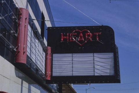 The Heart Theater marquee on Main Street in Hartford, Michigan, with red neon letters and a heart above a blank letter board, photographed in 1991