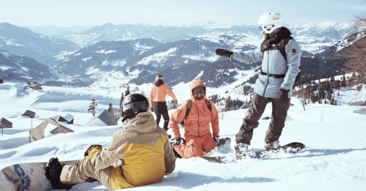 Group of snowboarders enjoying snowy mountain view.