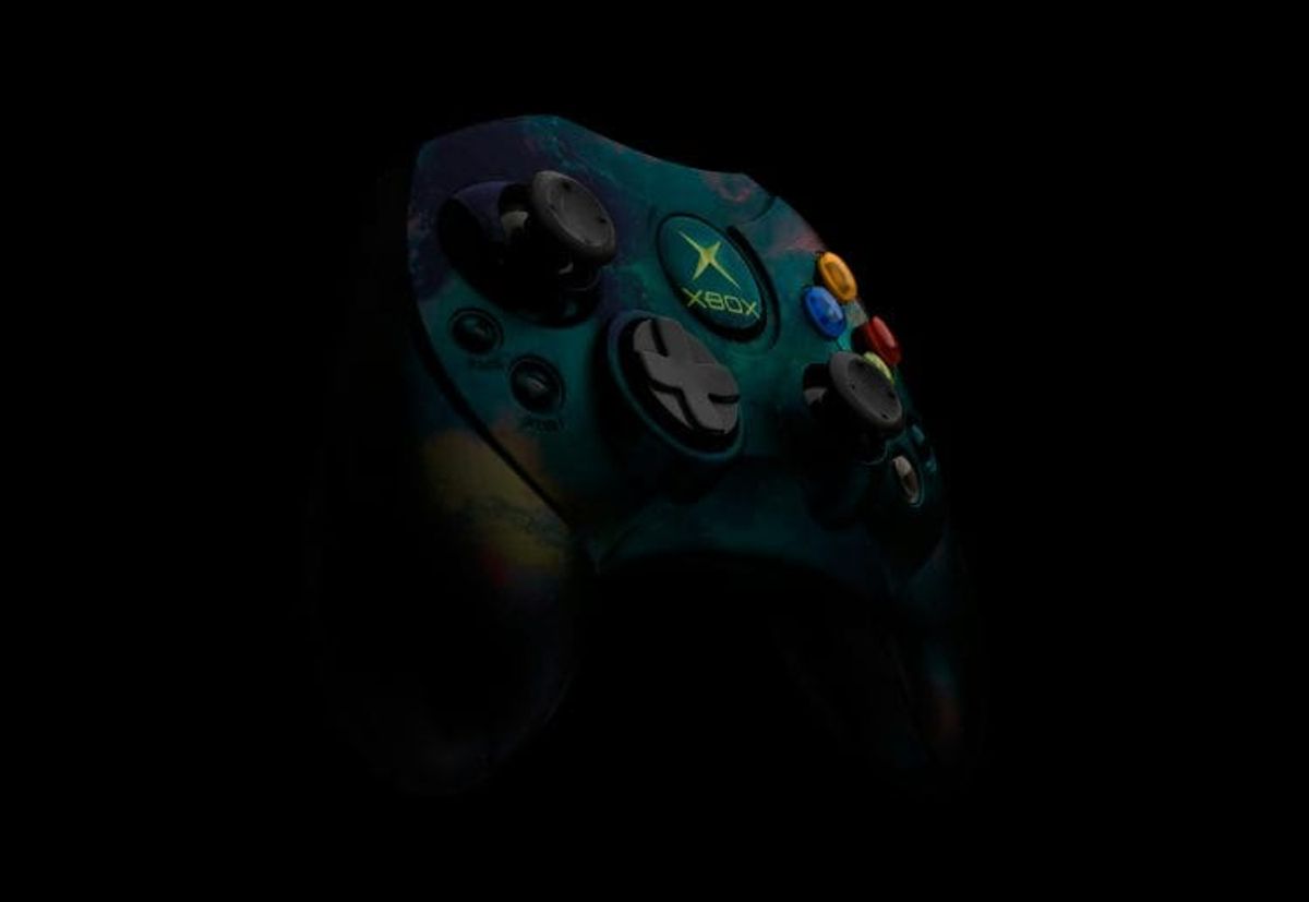 Colorful Xbox controller on dark background.