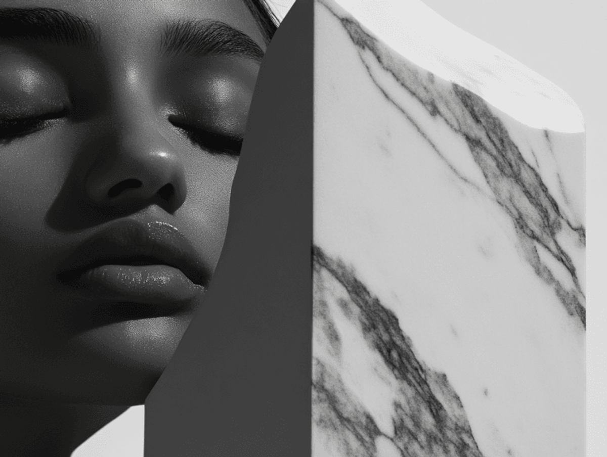 Woman beside marbled stone in artistic black and white.