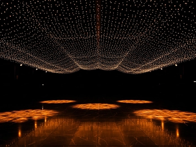 Elegant dark event venue with dramatic warm lighting