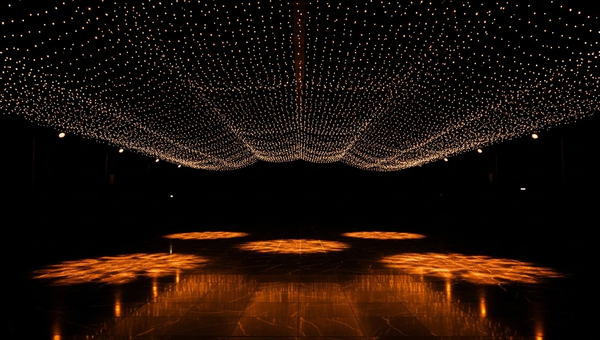 Elegant dark event venue with dramatic warm lighting