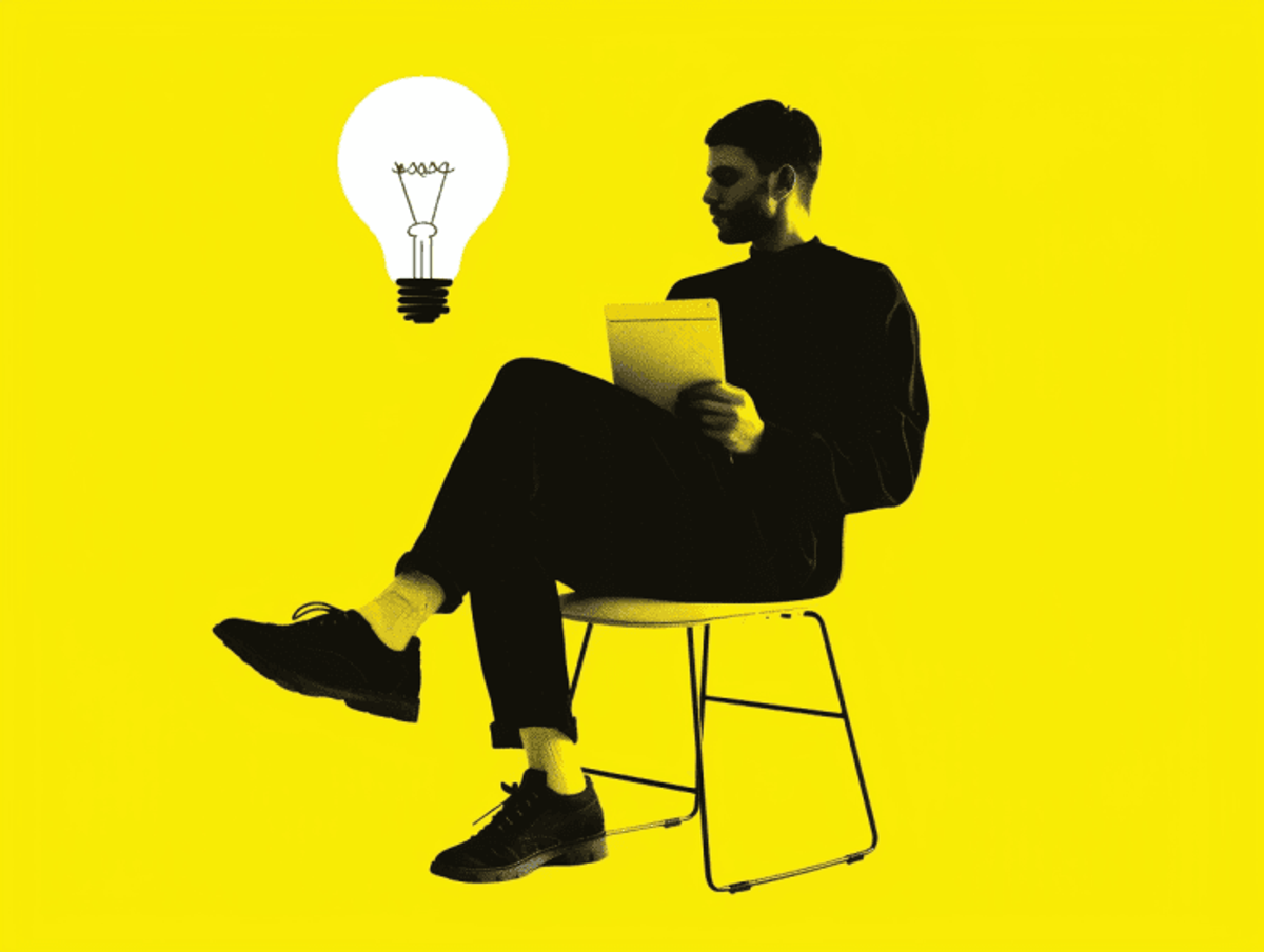 Silhouette with tablet and yellow lightbulb