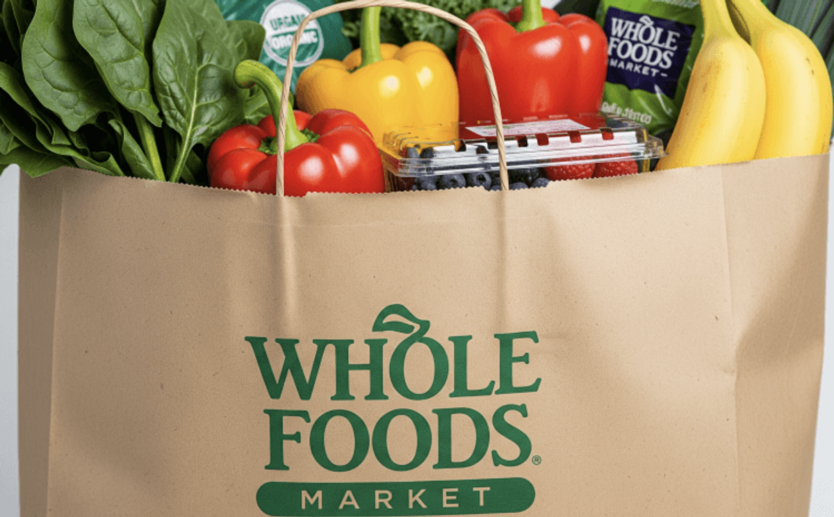 Grocery bag with fresh produce and Whole Foods logo.