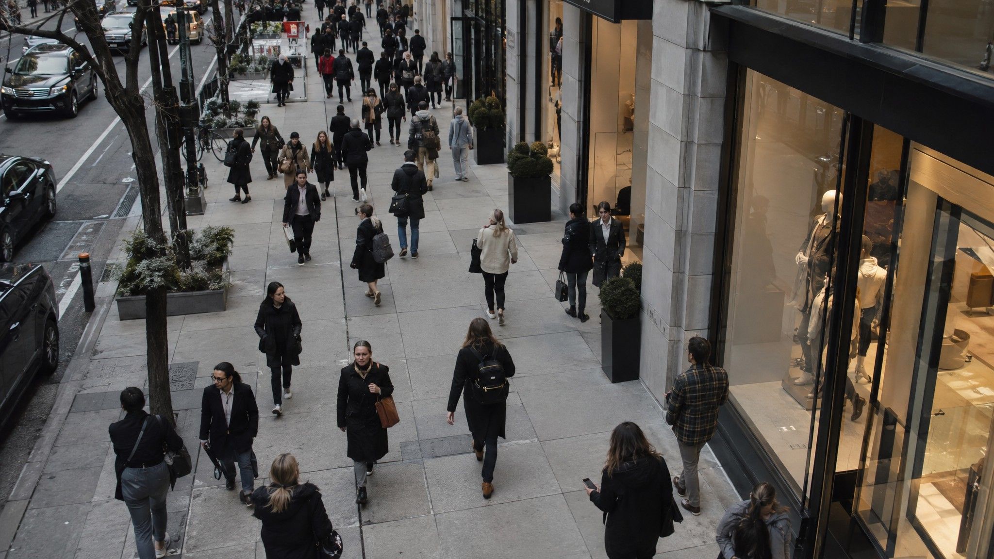 Busy shopping street seen from a mezzanine on a grey afternoon