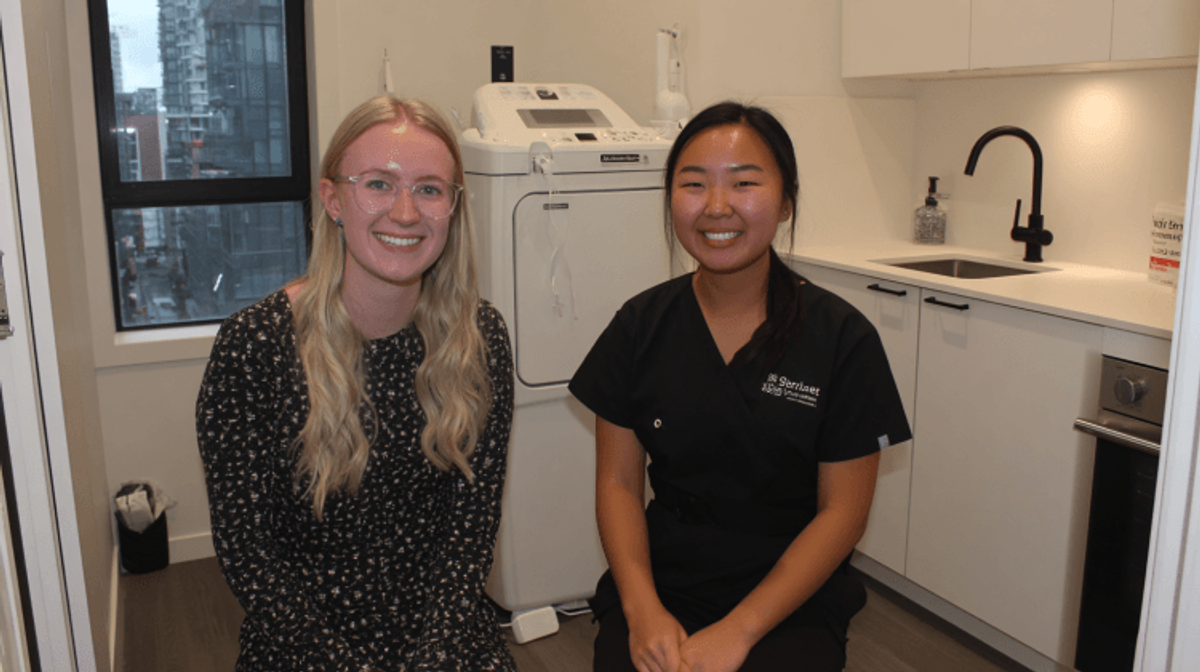 Two women smiling in a skincare clinic.
