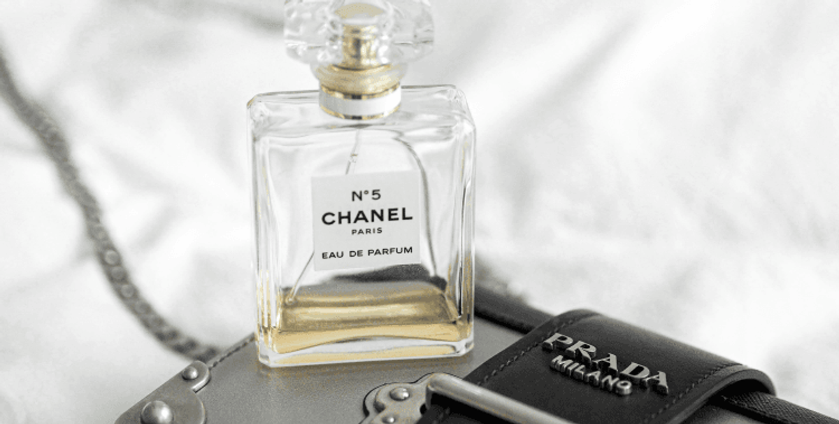 Chanel No. 5 perfume bottle on Prada bag