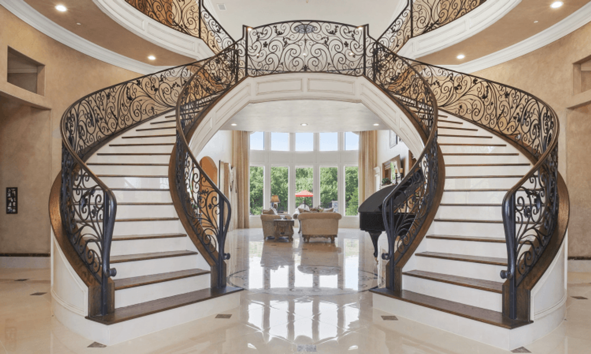 Elegant spiral staircase in luxury home interior.