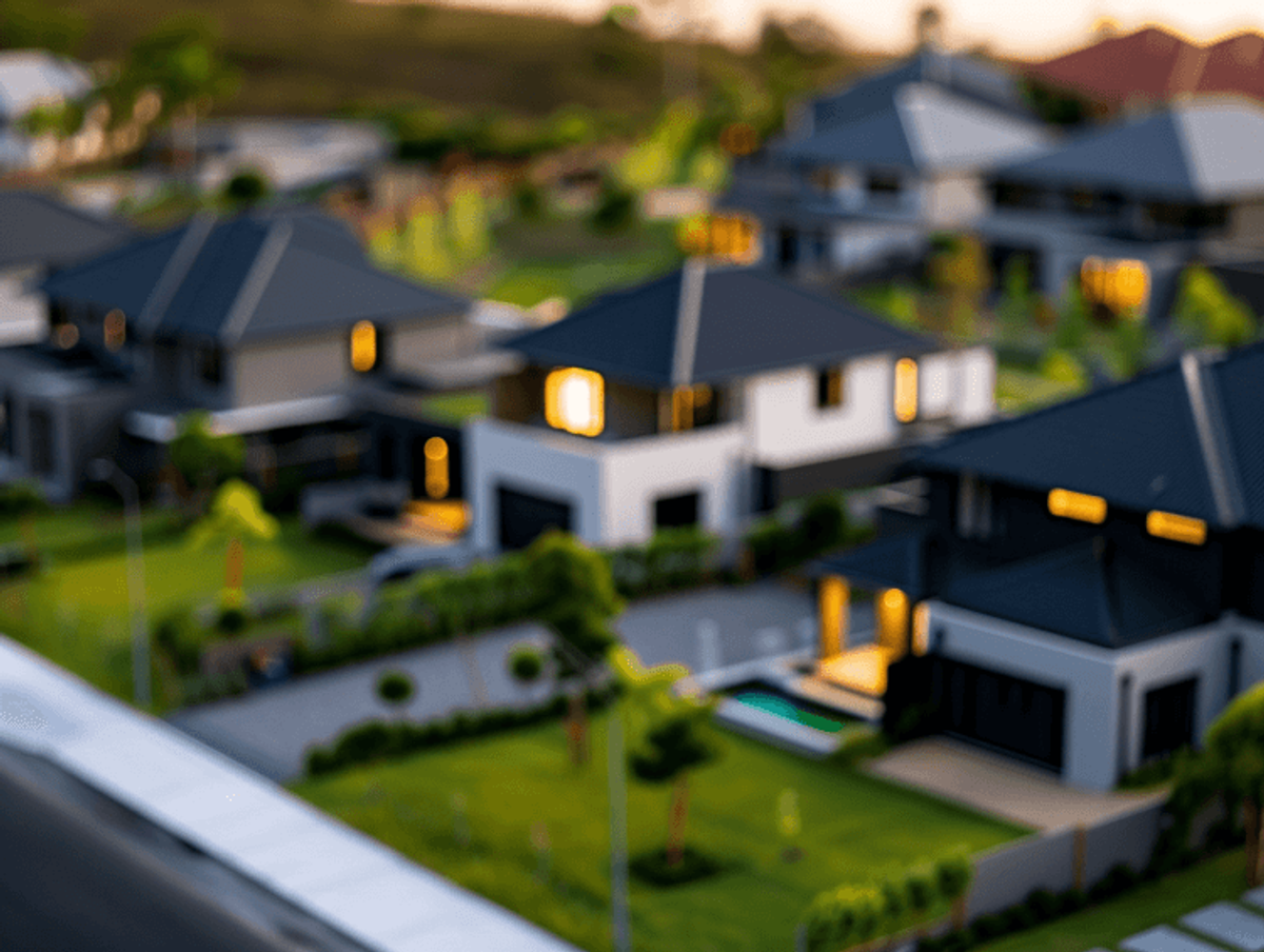 Blurred view of suburban neighborhood at dusk.