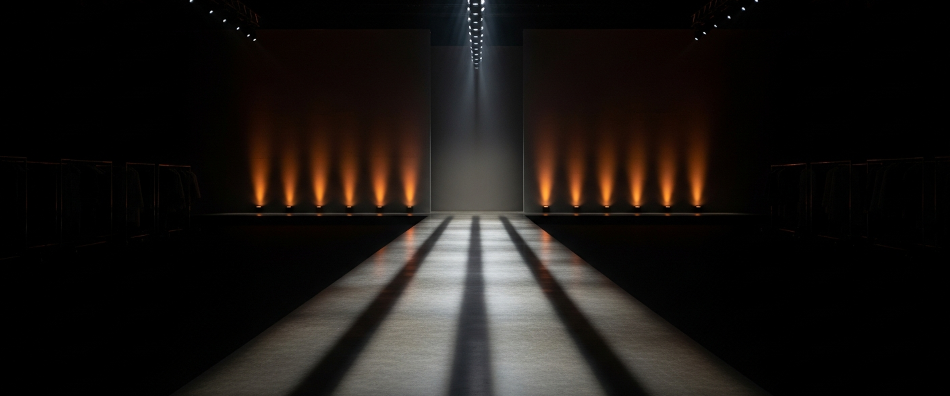 Dark moody fashion runway setup with dramatic spotlight and deep shadows