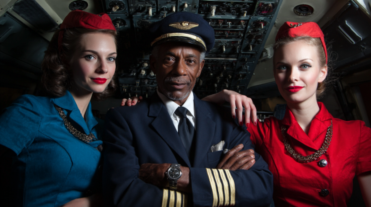 Pilot with two flight attendants in vintage uniforms.