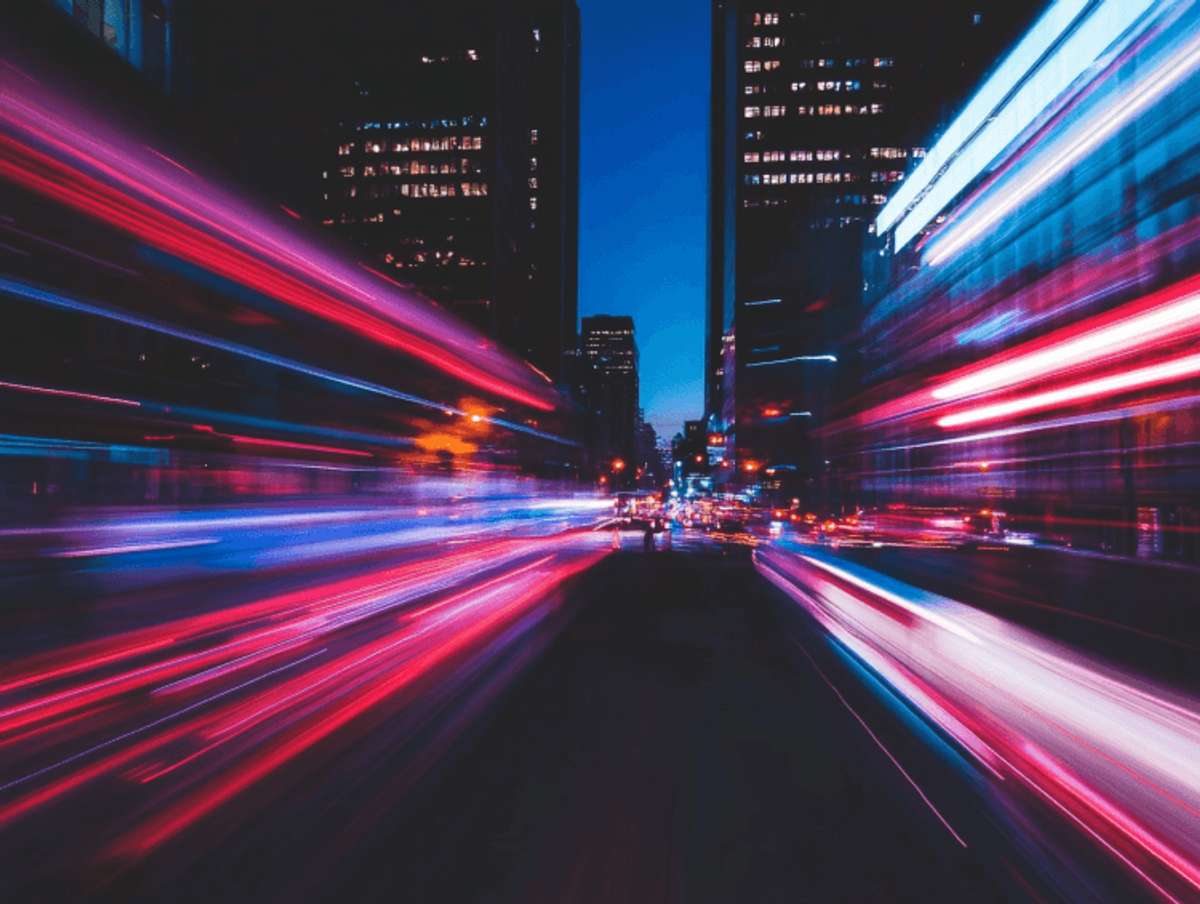 Colorful light trails in city nighttime scene.