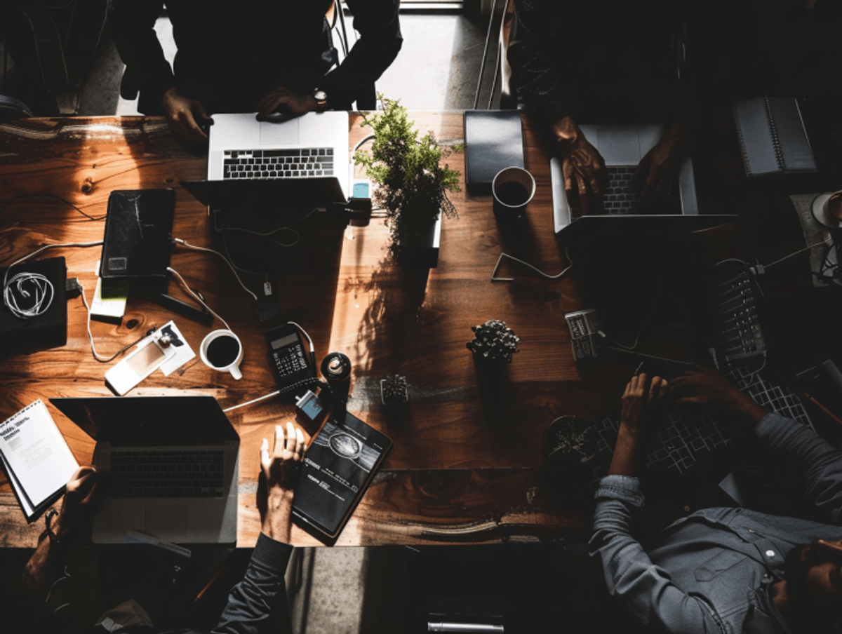 People working together on laptops in office setting.