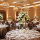 Elegant ballroom prepared for a gala event with crystal chandeliers and ambient lighting