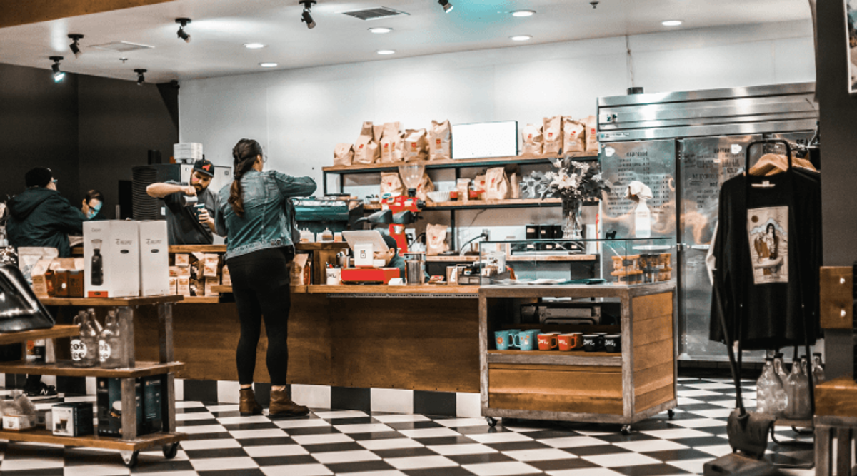 Barista preparing coffee in modern cafe.