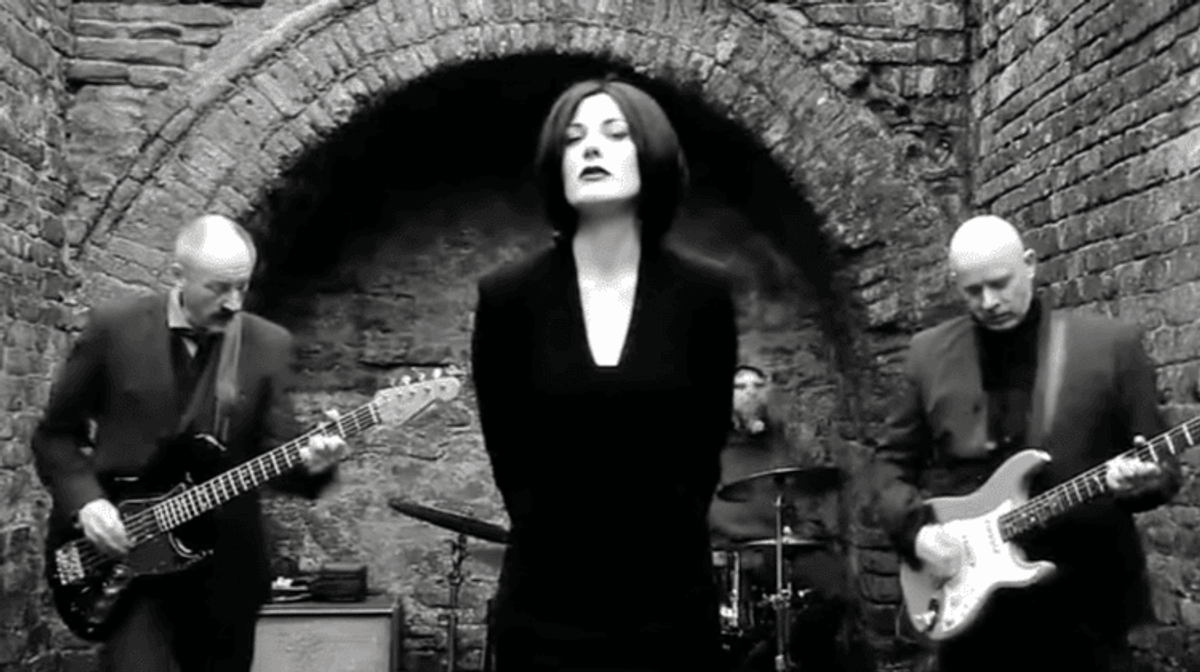 Band performing in a brick-walled courtyard