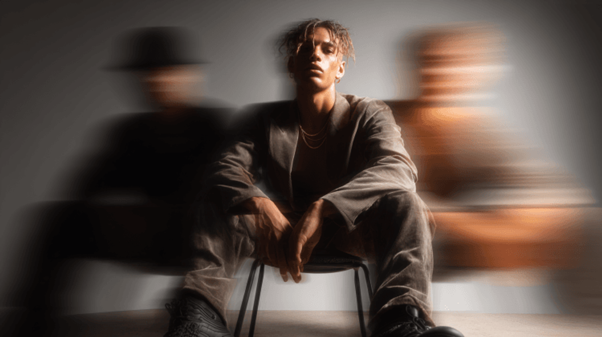 Person in motion blur effect, sitting on chair.