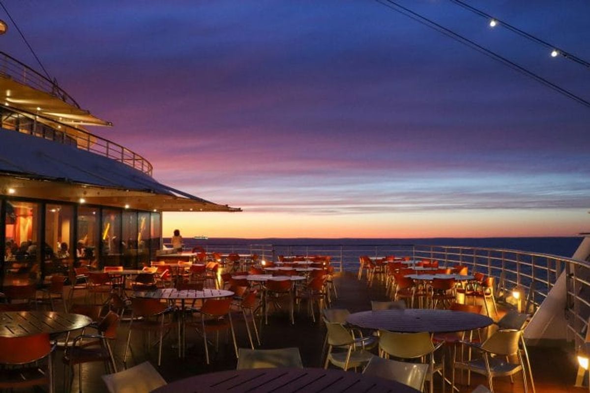 Cruise ship deck with sunset view.