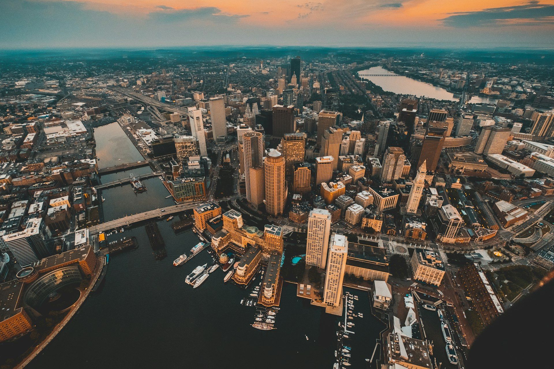 Boston skyline and harbor at dusk - Public Relations in Boston