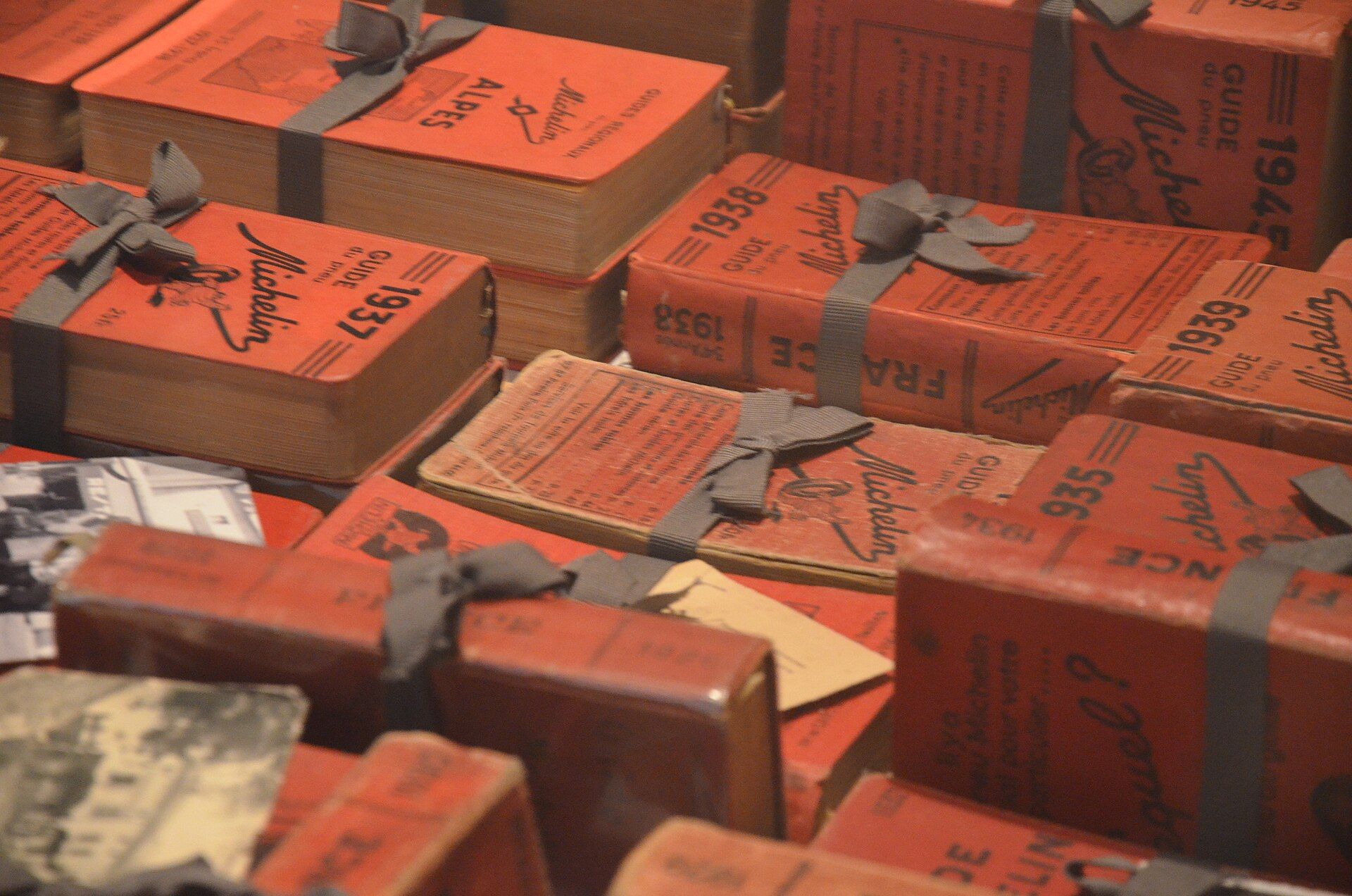 Rows of red Michelin Guides from the 1930s and 1940s, tied with ribbon, from the collection of the Pic restaurant in Valence