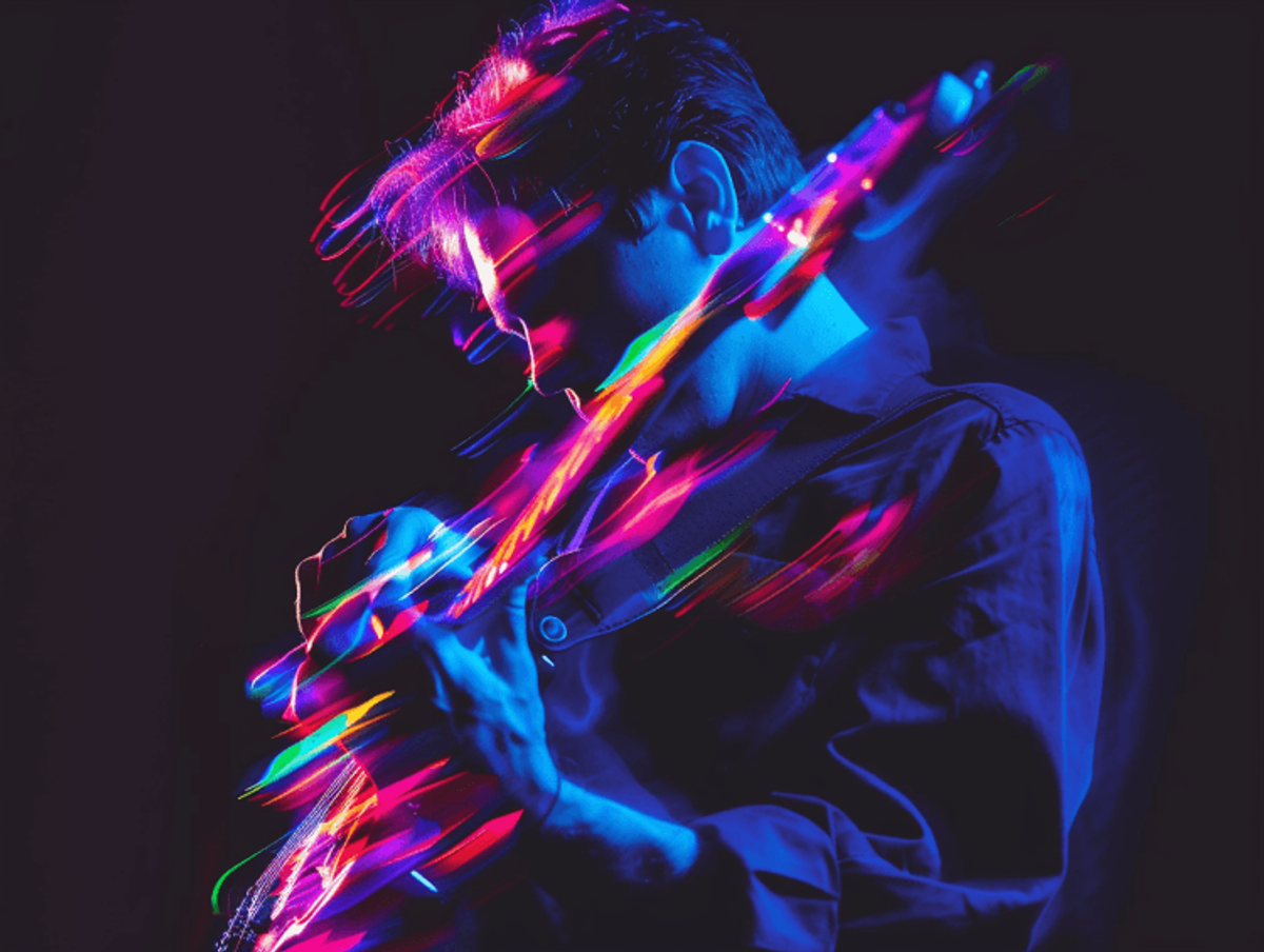 Guitarist performing with colorful neon lighting effects.