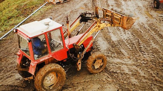 tractor moving mud
